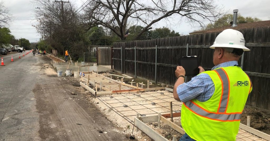 auto RHSI contractor taking photo with iPad.